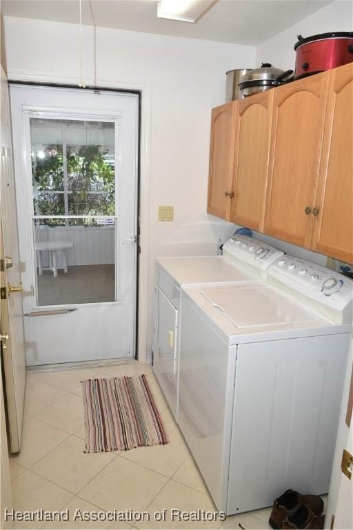 3603 Herring Ave, Sebring, FL 33870 - laundry area featuring cabinet space, light tile patterned floors, and independent washer and dryer