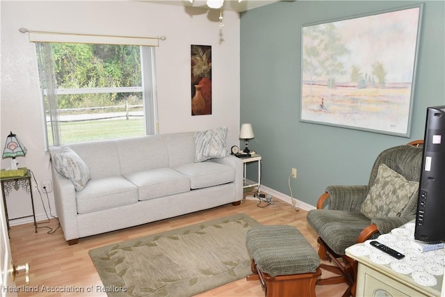 3603 Herring Ave, Sebring, FL 33870 - living room with ceiling fan, light wood finished floors, and baseboards