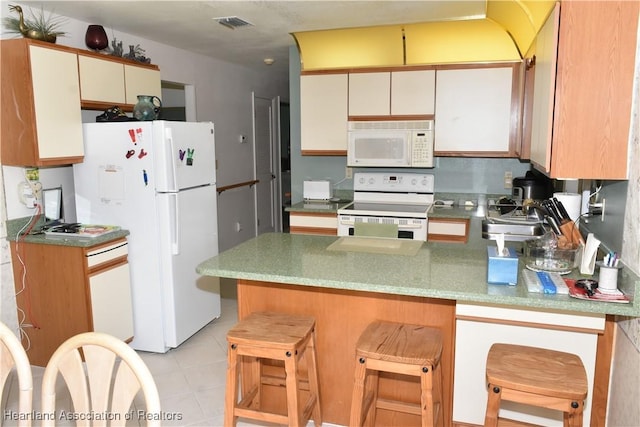 3603 Herring Ave, Sebring, FL 33870 - kitchen featuring light tile patterned floors, white appliances, a peninsula, visible vents, and a sink