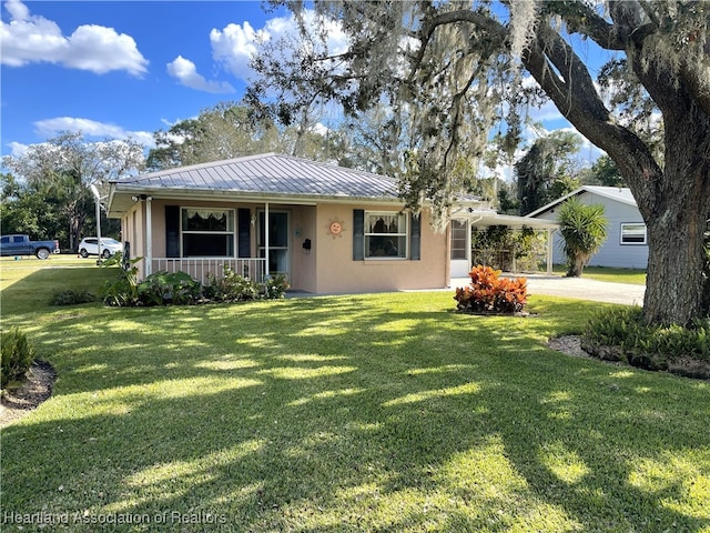 3603 Herring Ave, Sebring, FL 33870 - single story home featuring a carport, stucco siding, a front yard, a porch, and metal roof