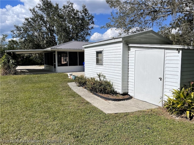 3603 Herring Ave, Sebring, FL 33870 - exterior space with a storage shed, an outdoor structure, a sunroom, and a lawn