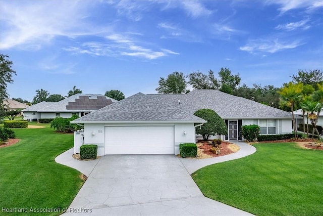 ranch-style home featuring a garage, a front lawn, and solar panels