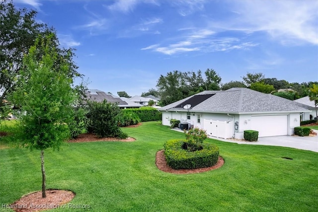 view of yard with central AC unit and a garage