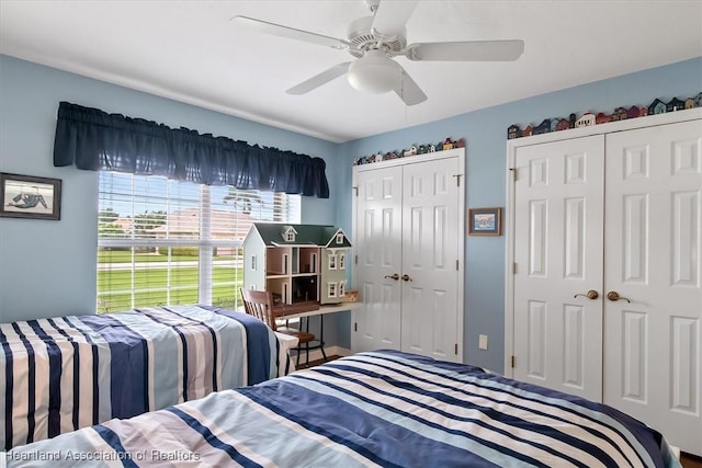 bedroom with ceiling fan and multiple closets