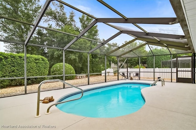 view of swimming pool featuring a patio area and a lanai