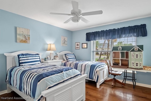 bedroom with ceiling fan and dark hardwood / wood-style floors