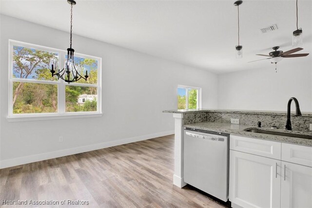 kitchen featuring white cabinetry, dishwashing machine, sink, and decorative light fixtures