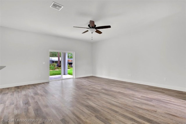 empty room with ceiling fan and light wood-type flooring