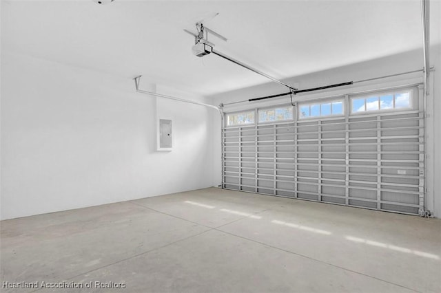 garage featuring a garage door opener and electric panel