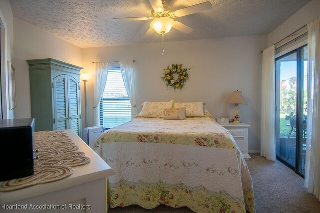 carpeted bedroom with ceiling fan, a textured ceiling, and access to outside