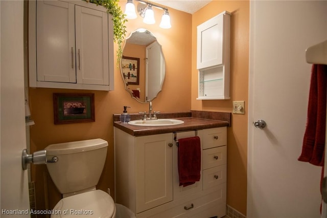 bathroom with toilet and vanity