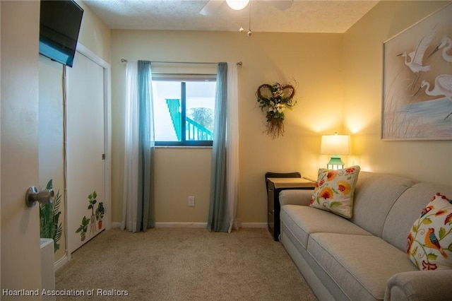 carpeted living room featuring ceiling fan