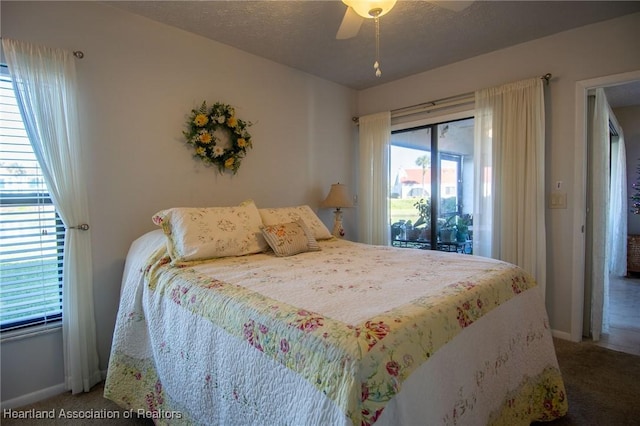 bedroom with carpet floors, ceiling fan, access to exterior, and a textured ceiling