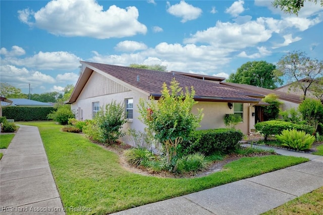 view of side of property with a yard