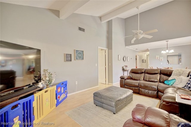 living room featuring high vaulted ceiling, light hardwood / wood-style flooring, beam ceiling, and ceiling fan with notable chandelier