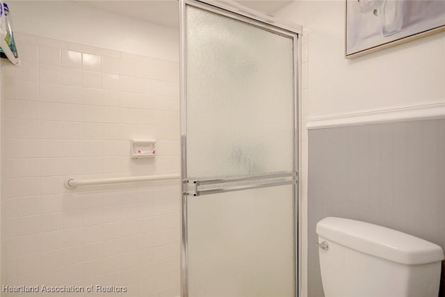 bathroom featuring toilet and walk in shower