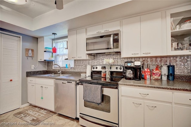 kitchen featuring sink, white cabinets, decorative backsplash, and stainless steel appliances