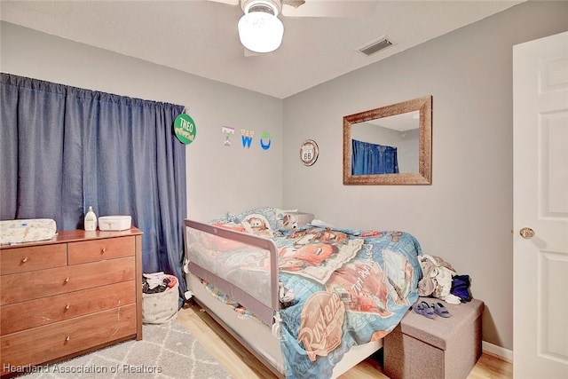 bedroom with light wood-type flooring and ceiling fan