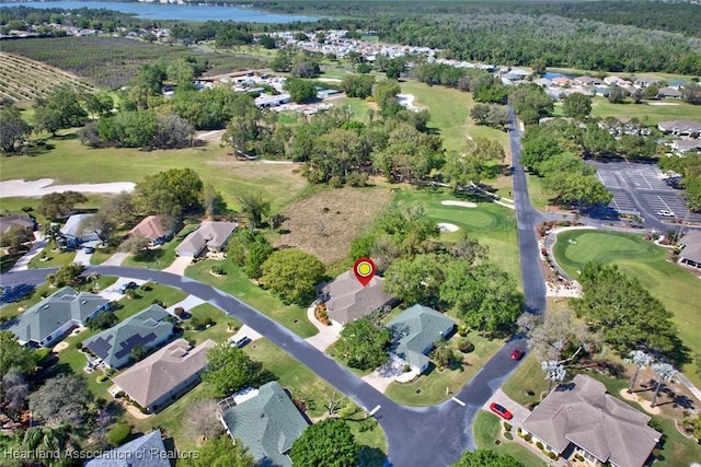 bird's eye view with view of golf course, a residential view, and a water view