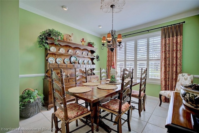 dining area featuring an inviting chandelier, light tile patterned floors, and ornamental molding