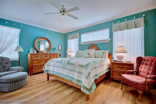 bedroom with multiple windows, wood finished floors, and crown molding