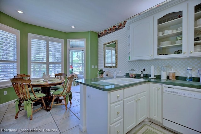 kitchen featuring dishwasher, white cabinetry, glass insert cabinets, and a sink