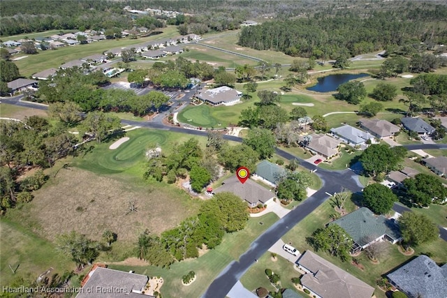 aerial view with a residential view, a water view, and golf course view