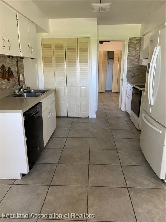 kitchen with sink, white appliances, tile patterned flooring, backsplash, and white cabinets