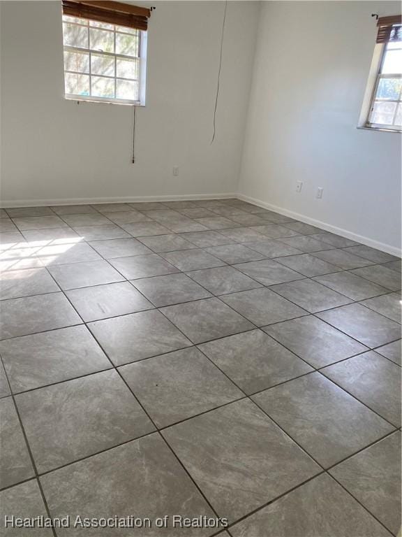 unfurnished room featuring light tile patterned floors