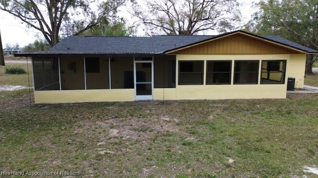 rear view of house featuring central AC and a sunroom