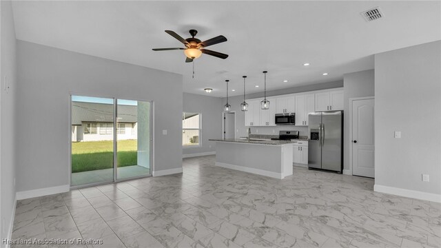 19 N Irvington Rd, Avon Park, FL 33825 - kitchen featuring stainless steel appliances, ceiling fan, a center island with sink, white cabinets, and hanging light fixtures