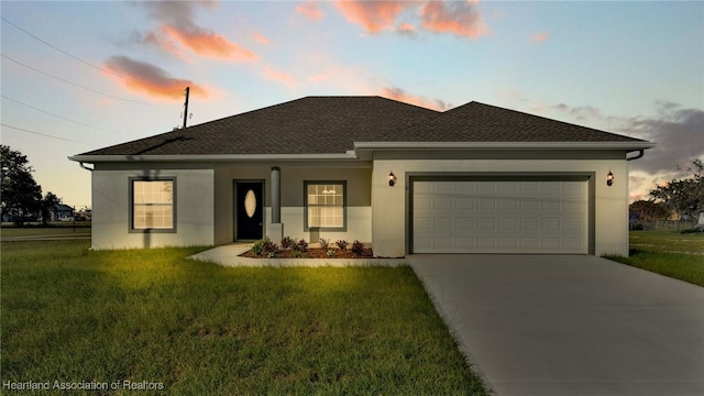 view of front facade featuring a yard and a garage