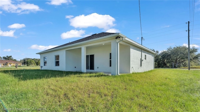 19 N Irvington Rd, Avon Park, FL 33825 - rear view of property with a lawn