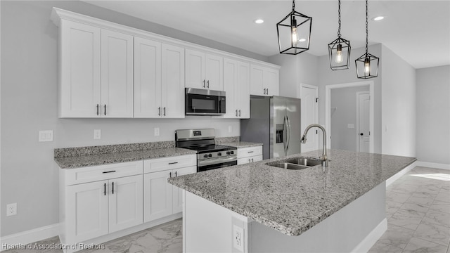 19 N Irvington Rd, Avon Park, FL 33825 - kitchen with white cabinets, appliances with stainless steel finishes, decorative light fixtures, and a center island with sink