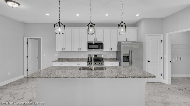 19 N Irvington Rd, Avon Park, FL 33825 - kitchen with a kitchen island with sink, sink, appliances with stainless steel finishes, light stone counters, and white cabinetry