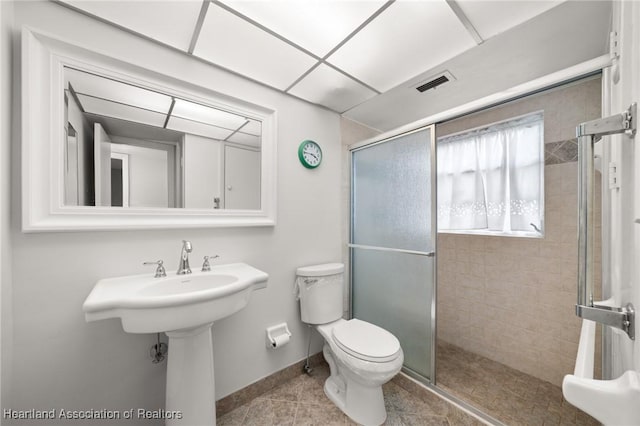 2111 Lakeview Dr Unit 1A, Sebring, FL 33870 - bathroom with a stall shower, toilet, baseboards, tile patterned floors, and a sink