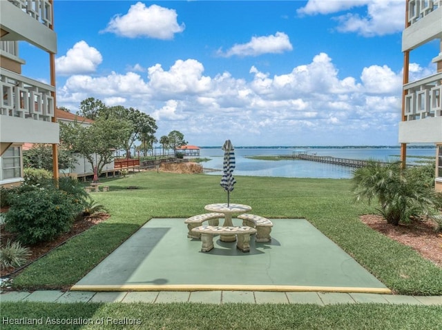2111 Lakeview Dr Unit 1A, Sebring, FL 33870 - view of grassy yard with a water view and a patio area