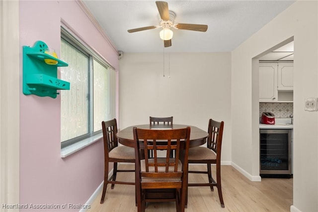 2111 Lakeview Dr Unit 1A, Sebring, FL 33870 - dining space with wine cooler, light wood finished floors, ceiling fan, and baseboards