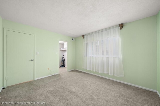 2111 Lakeview Dr Unit 1A, Sebring, FL 33870 - carpeted spare room featuring baseboards and a textured ceiling