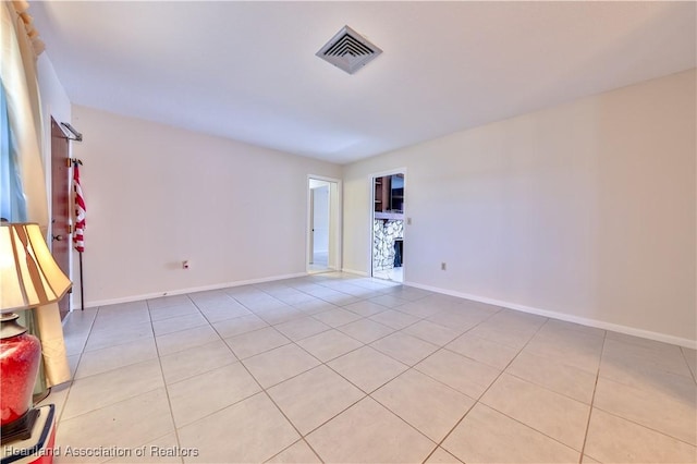 tiled empty room with a fireplace