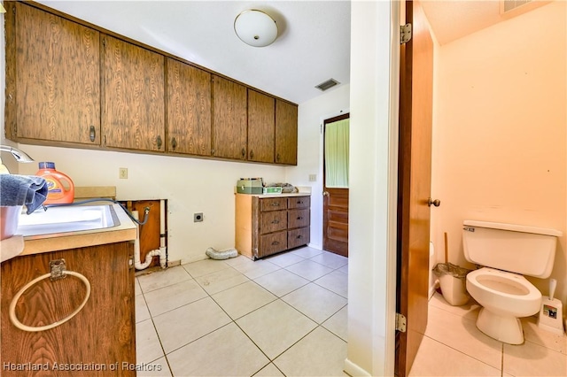 interior space with tile patterned floors, vanity, and toilet