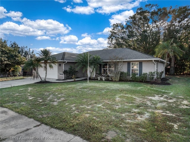 ranch-style home with a front yard and a garage