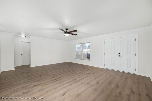 unfurnished living room with ceiling fan and wood-type flooring