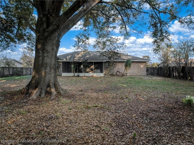 back of house with a sunroom