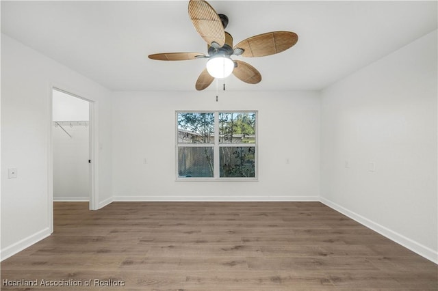 empty room with hardwood / wood-style flooring and ceiling fan