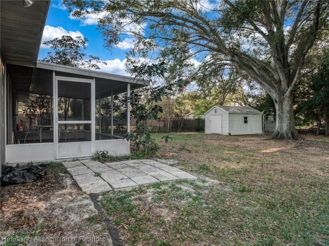 view of yard with a shed and a sunroom