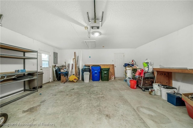 garage featuring electric panel and a garage door opener