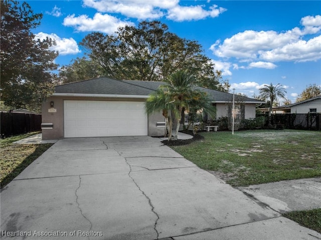 single story home with a front yard and a garage