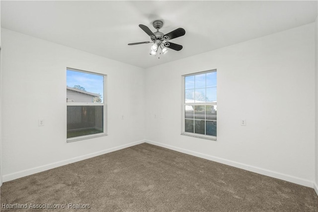 carpeted spare room with ceiling fan