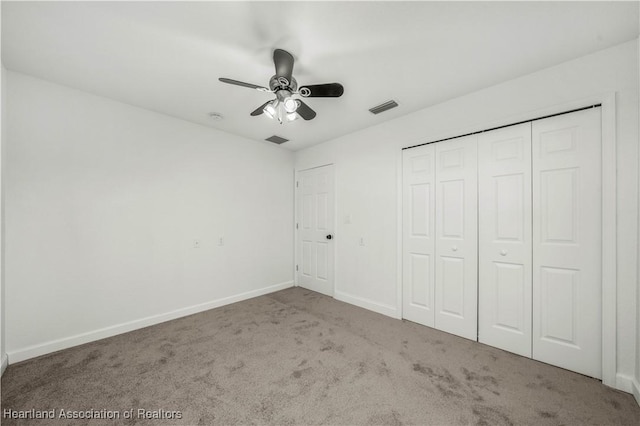 unfurnished bedroom featuring carpet, ceiling fan, and a closet